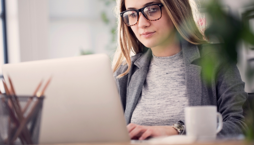 young woman looking at laptop
