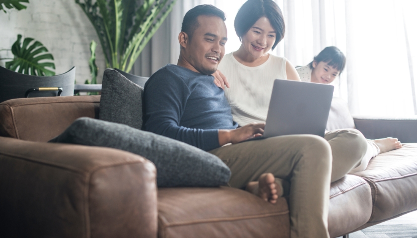 family looking at laptop