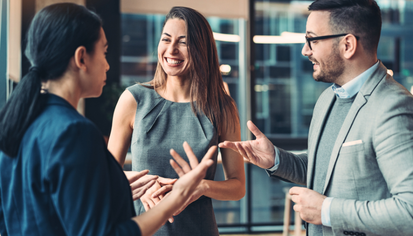 three professionals chatting at networking event