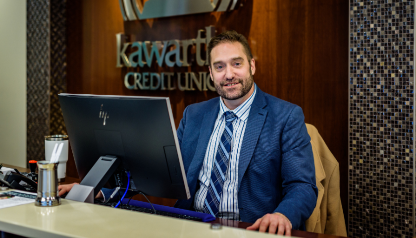 smiling man sitting at desk