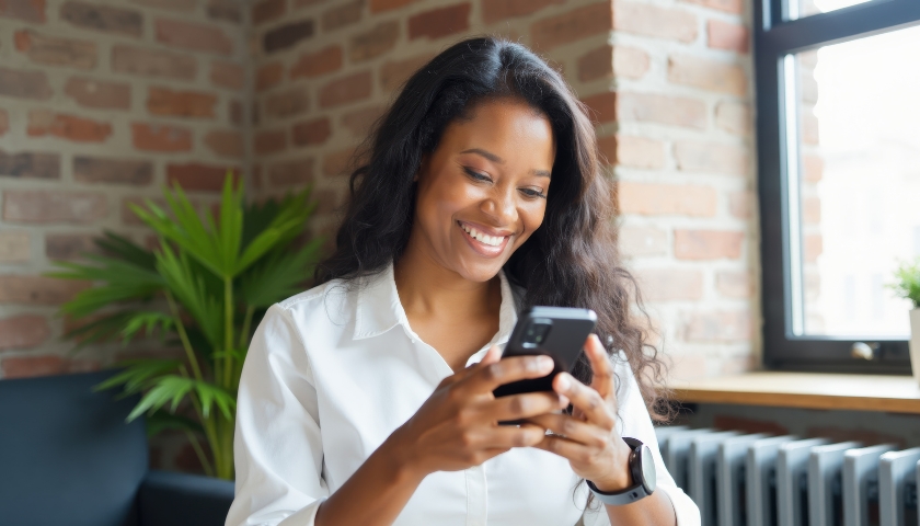 Smiling woman looking at cell phone