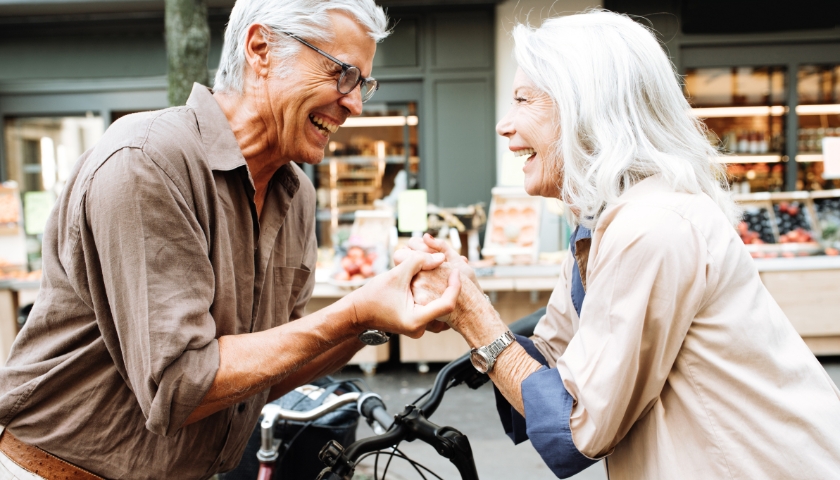 Elderly couple holding hands.